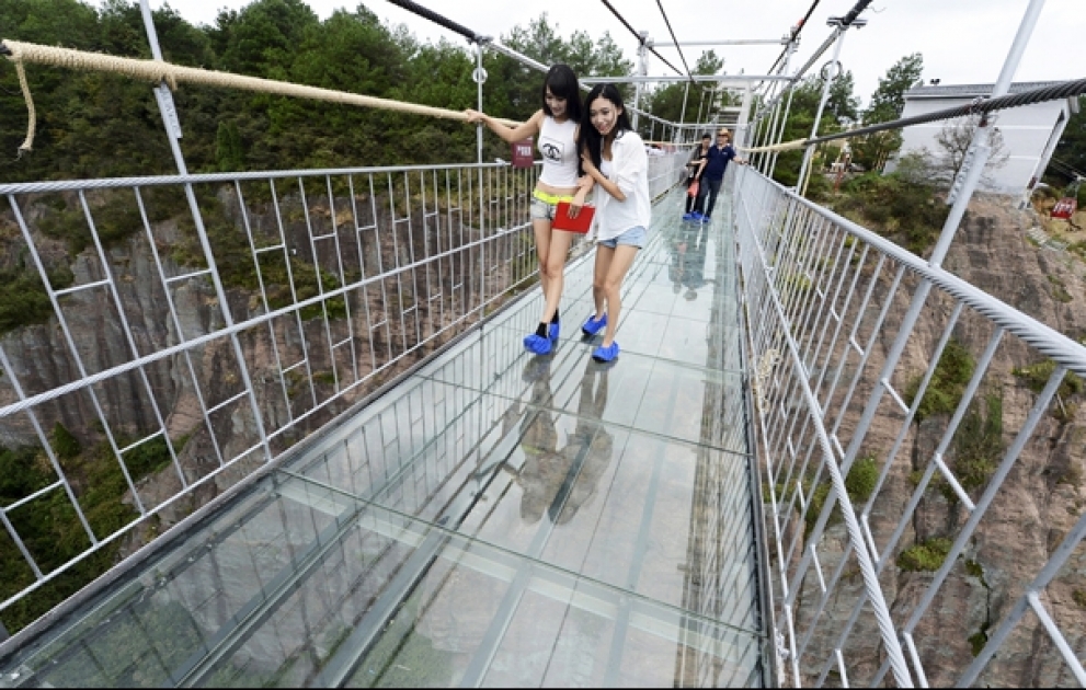 China's first glass-bottomed suspension bridge is giving terrified tourists a heart-stopping day out