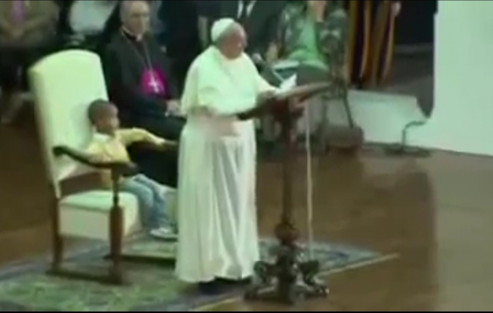 Boy sits in Papal chair