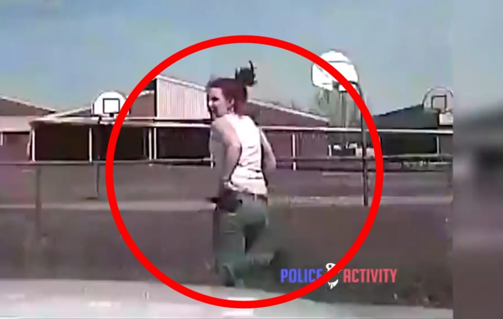 Police runs over an armed woman with car