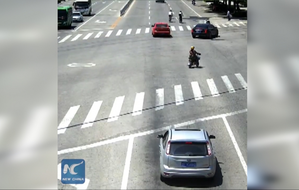 Driver stops car near crosswalk to help elderly lady cross the street