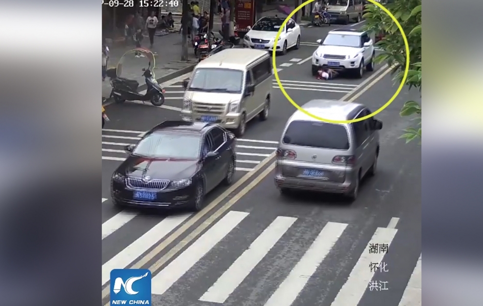 A boy was trapped under the wheels after being hit by a car in Hunan, China
