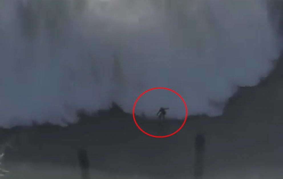 A surfer is wiped out by an enormous 20m wave