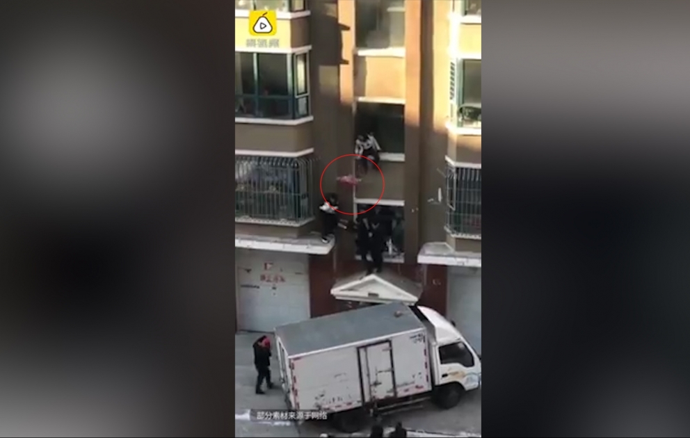 Woman drops baby from apartment block window while trying to escape fire