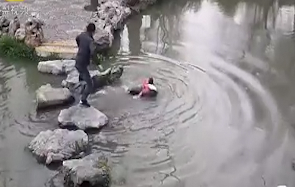 Grandmother falls into water carrying her grandchild