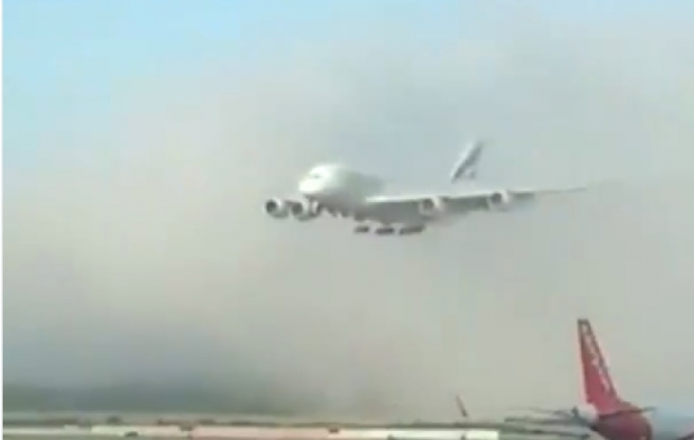 A380 plane suddenly appears out of cloud during landing