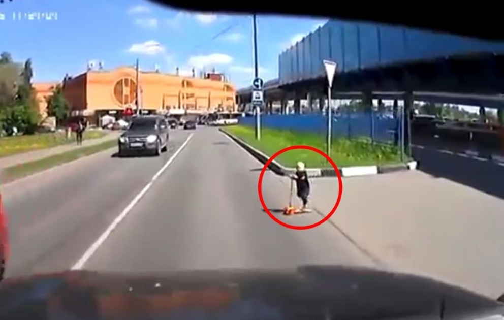 Child Rides into Middle of Busy Road