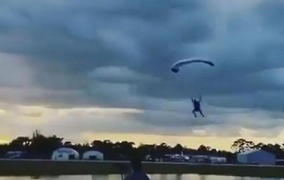 Guy Skydiving With Parachute Lands Hard on Water Surface