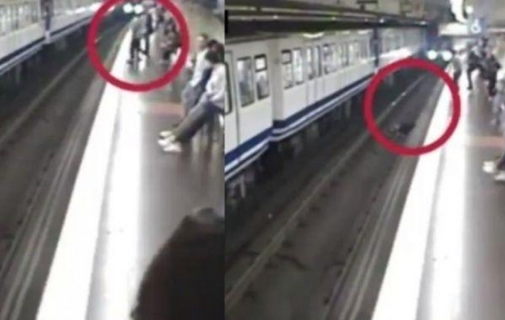 Woman distracted by mobile phone falls onto Madrid subway tracks