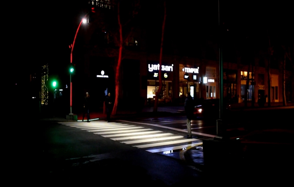 Pedestrian crossing on the central street of Baku illuminated with additional safety effects of lighting