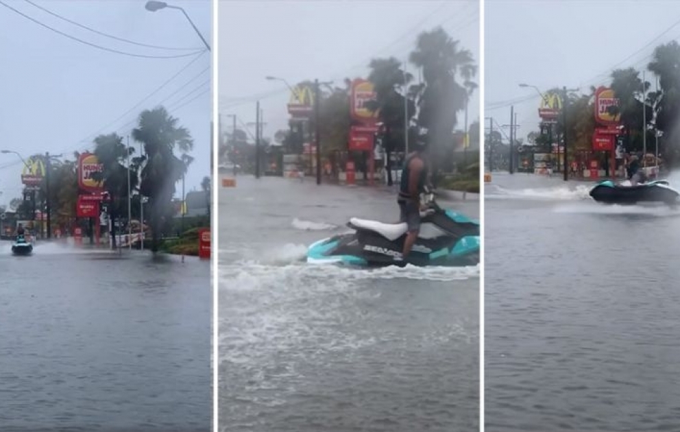 Man criticised for riding jet ski in flood waters near McDonald's