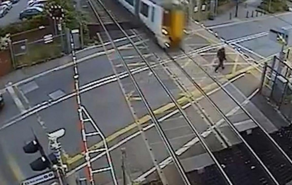 Shocking moment man nearly gets hit by train after forcing open barrier at north London level crossing
