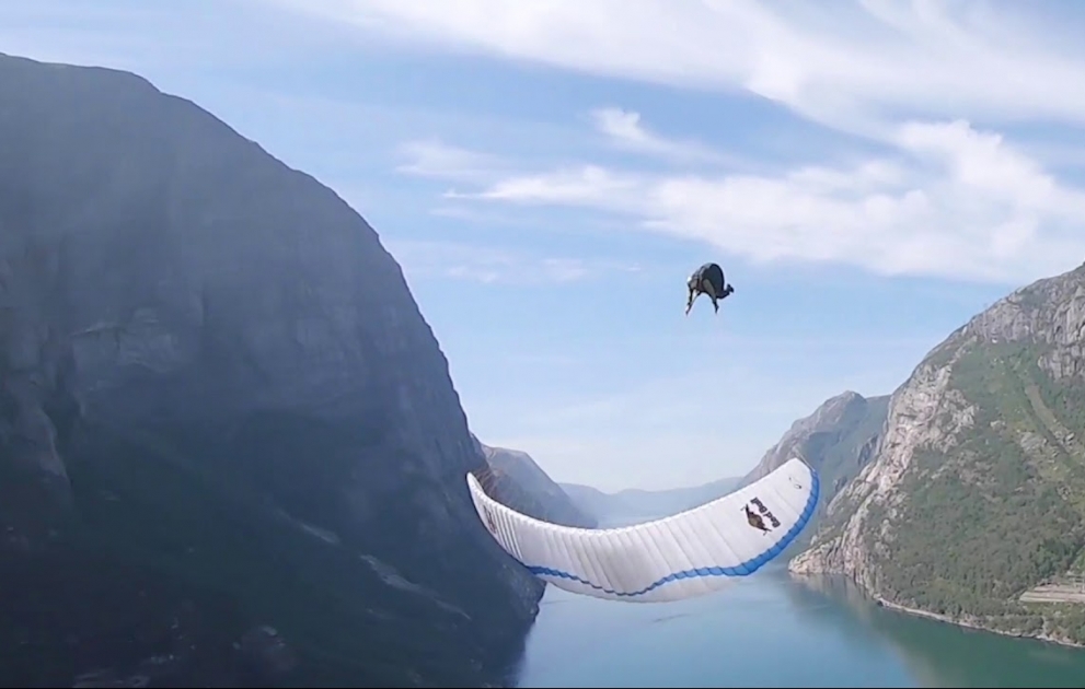 Daredevil performs front flips - while paragliding