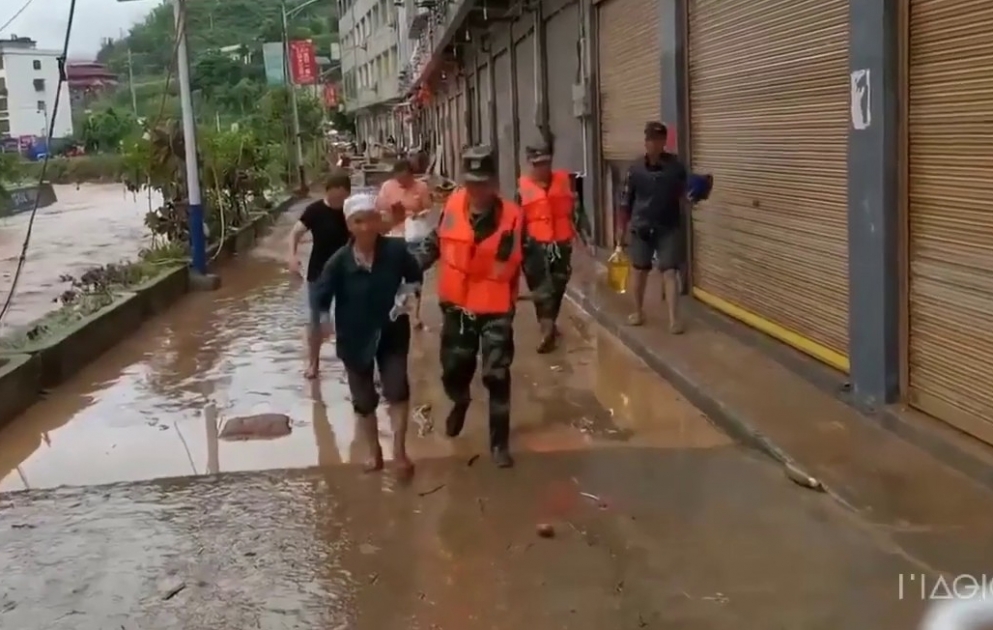 Armed police rescue people from flash floods in SW China