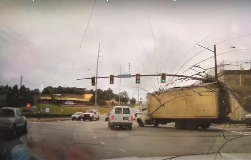 Truck Tips Over on to Cop Car