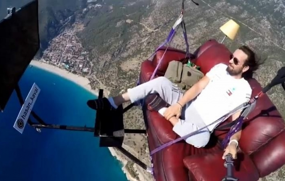 Daredevil paraglider takes to the sky on couch