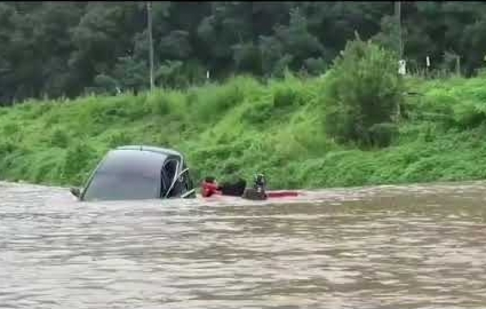 A woman was rescued from a half-submerged car in Cheongsong county in South Korea