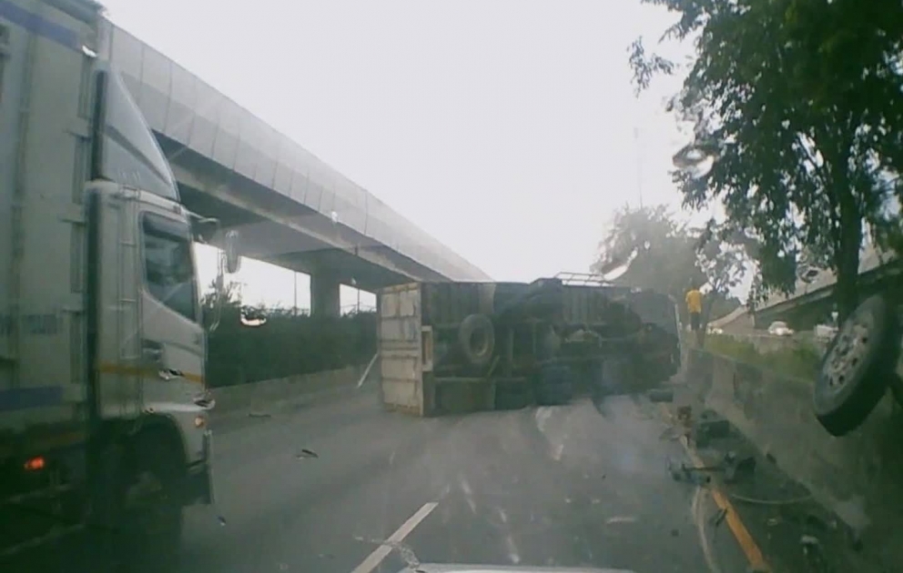 Truck Topples Over After Colliding With Barrier