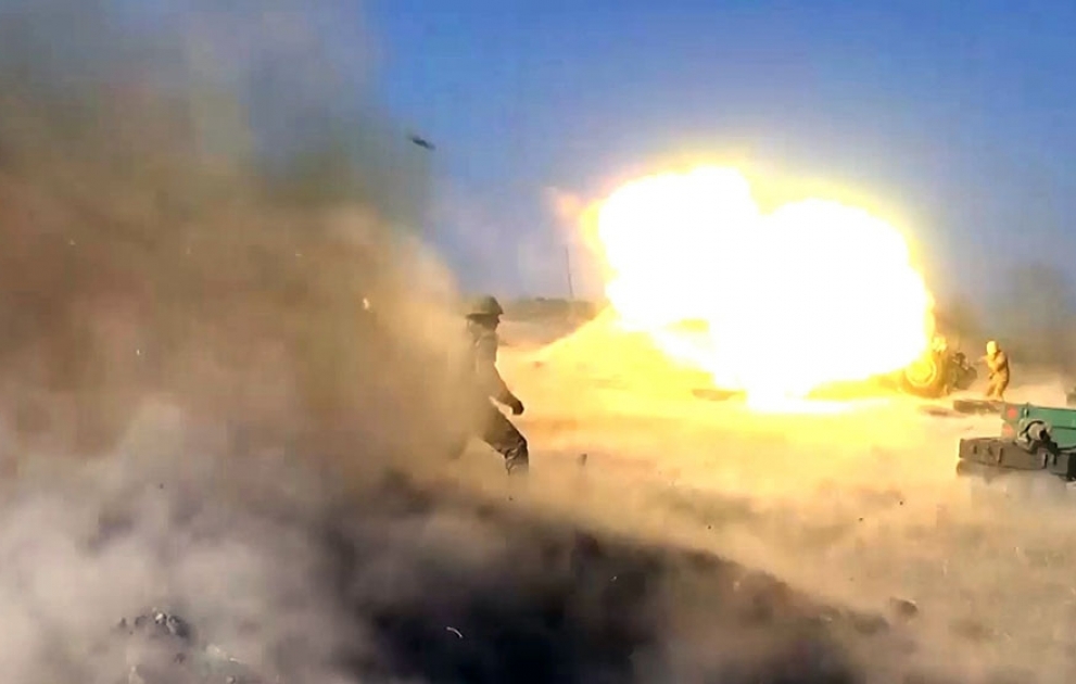 Launching rocket and artillery strikes against enemy positions