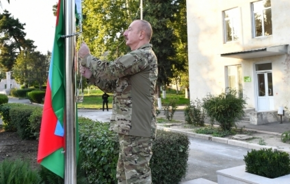 Präsident Ilham Aliyev hisst in der Stadt Khojavend aserbaidschanische Flagge