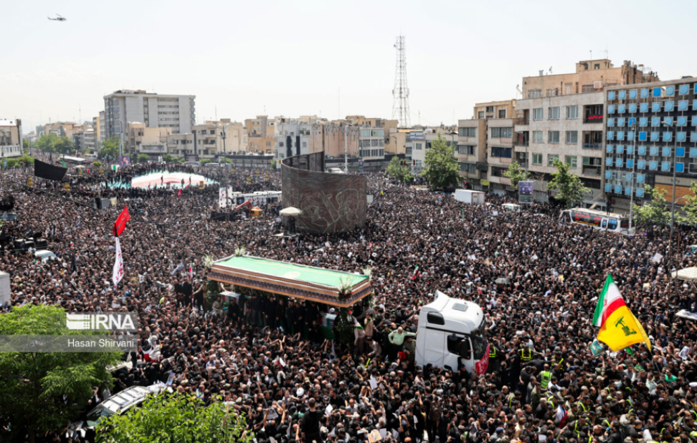 People in Iran bid farewell to late president